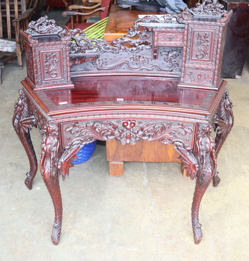 A Chinese carved wood concave shaped desk, W.130cm, D.60cm, H.110cm